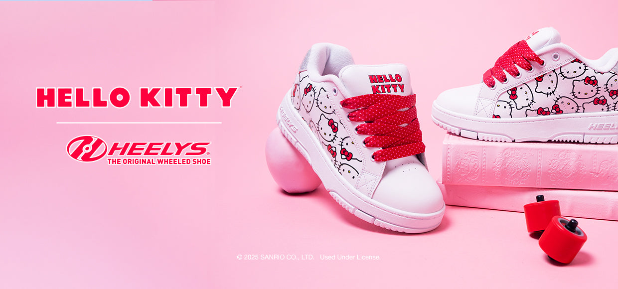 Hello Kitty Girls Heelys roller shoes on a pink background with 'Hello Kitty' and 'Heelys' branding.
