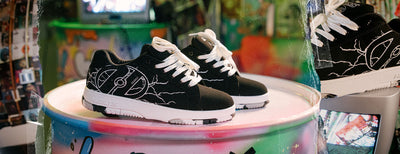 Boys Heelys roller shoes. Black Heelys with white soles on a colorful platform